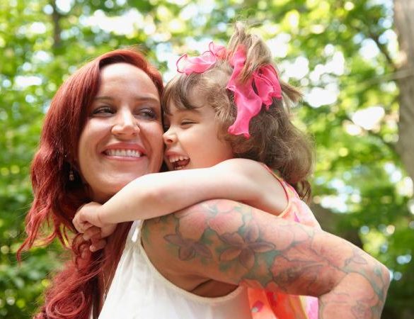 Mother carrying daughter piggyback