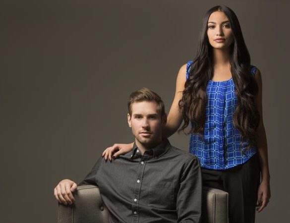 Couple posing by a chair