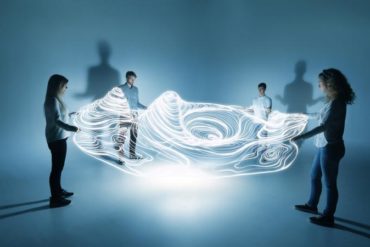 people holding a lighttrace carpet