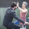 Skateboarder and businessman in suit high five