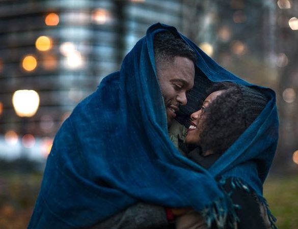 Romantic couple wrapped in blanket