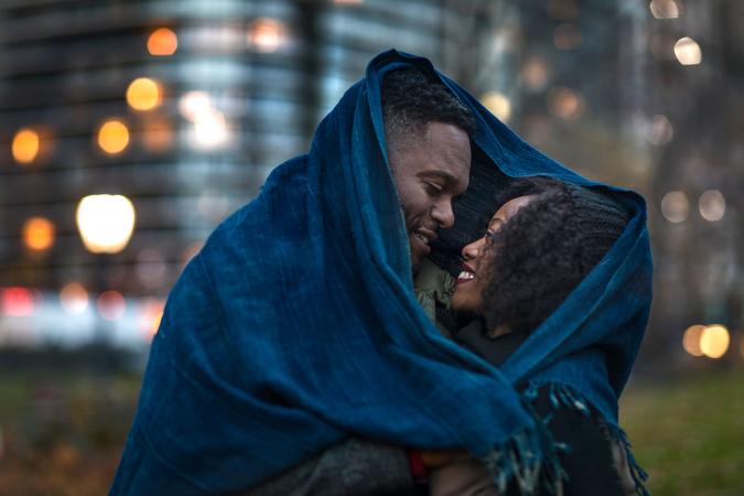 Romantic couple wrapped in blanket