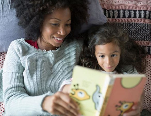 Mother and daughter reading book together