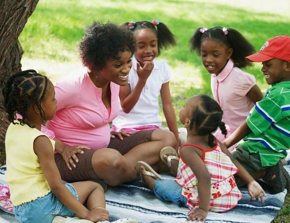 Mother with her children gathered around her at the park