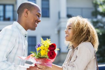 Man giving woman flowers