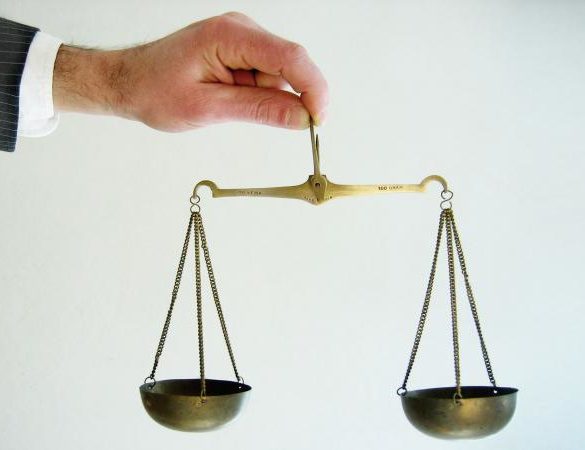 Man balancing set of scales