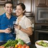 Couple drinking wine while cooking dinner