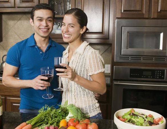 Couple drinking wine while cooking dinner