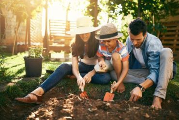 family gardening together in their backyard