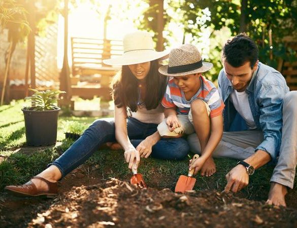 family gardening together in their backyard