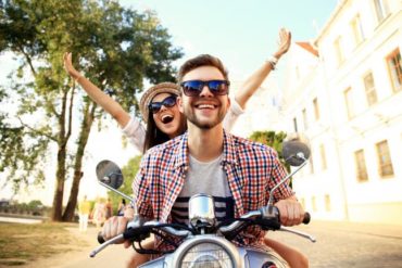 Happy couple on scooter