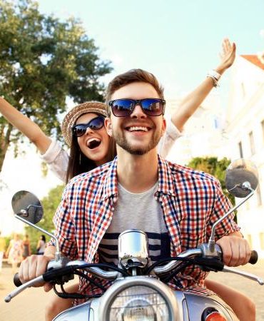 Happy couple on scooter