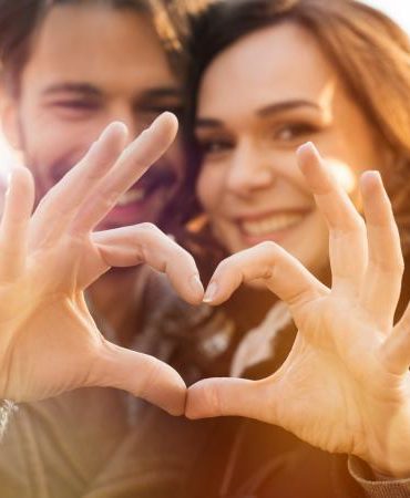 Couple making heart hands