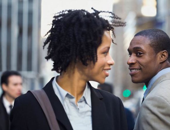 businesswoman making eye contact with man
