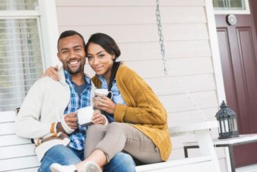 Young couple sitting on porch