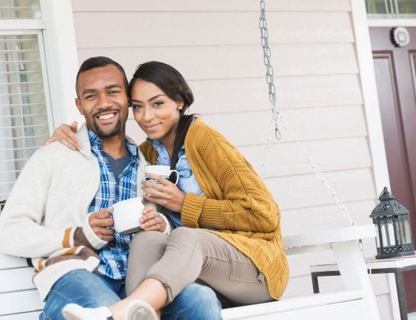 Young couple sitting on porch