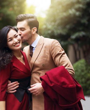 Handsome young couple, walking down the street in formal elegant clothes