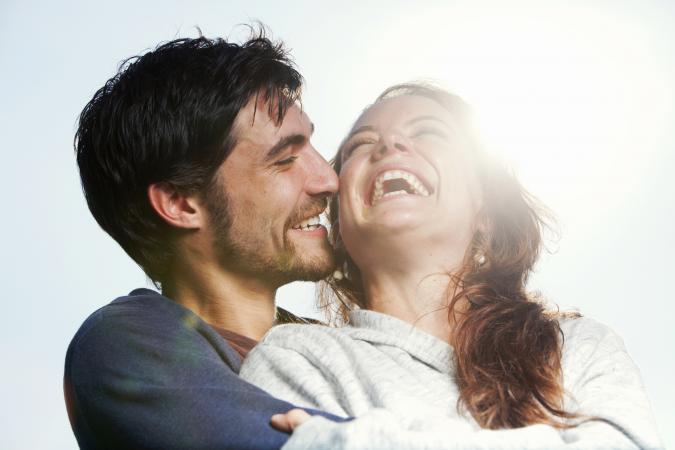 Young couple hugging and laughing together