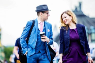 man and woman talking on street