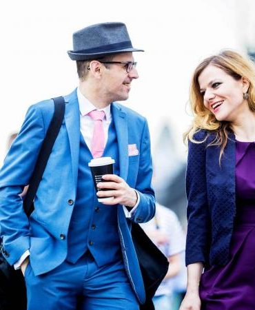 man and woman talking on street