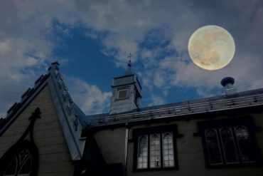 full moon over building