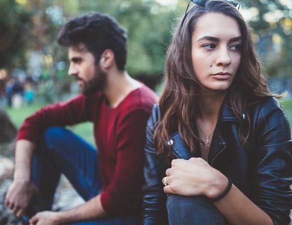 couple in the park feeling unhappy