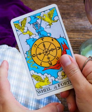Holding wheel of fortune tarot card