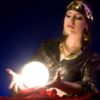 Woman with illuminated crystal orb