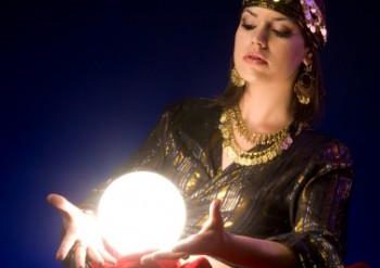 Woman with illuminated crystal orb