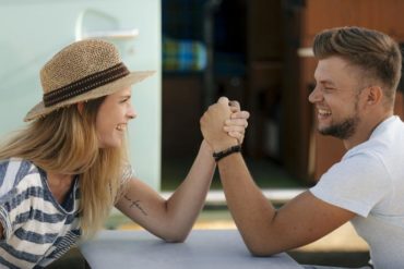 Man and woman arm wrestling