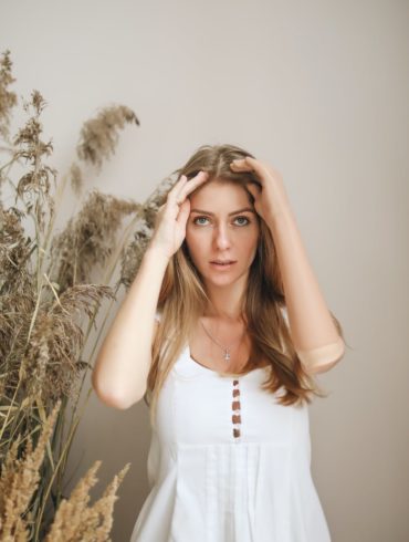 woman with prosthetic hand fixing her hair