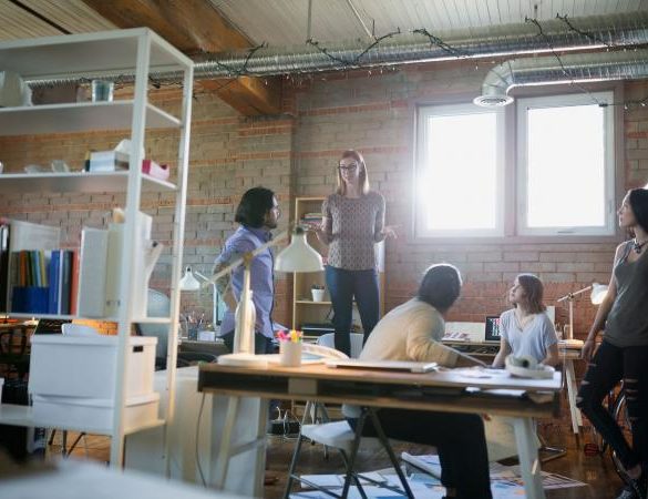 Designer leading a company office meeting