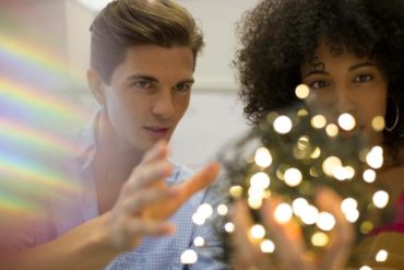 Couple examining ball of string lights