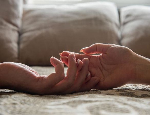 holding hands in bed