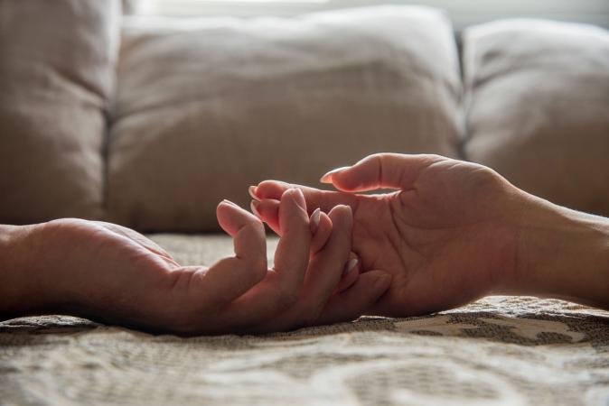 holding hands in bed