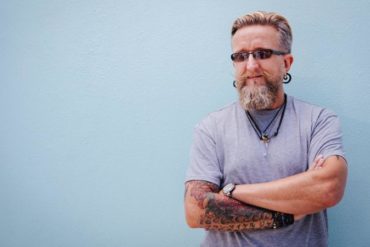 Portrait of stylish mature man with beard and tattoo