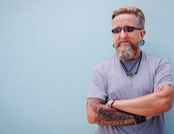 Portrait of stylish mature man with beard and tattoo