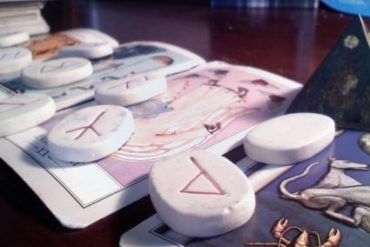 Tarot cards and runes used for a reading