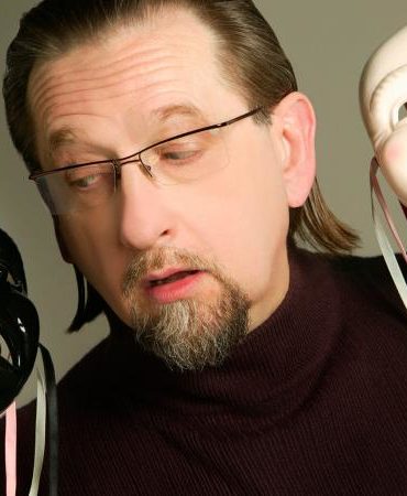 man holding happy and sad face