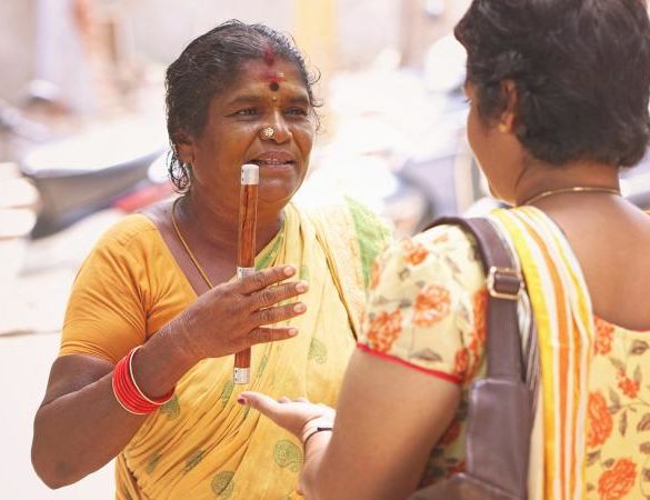 Female Indian astrologer talking with woman