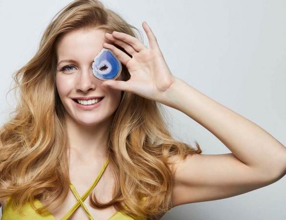 woman holding a blue agate gemstone