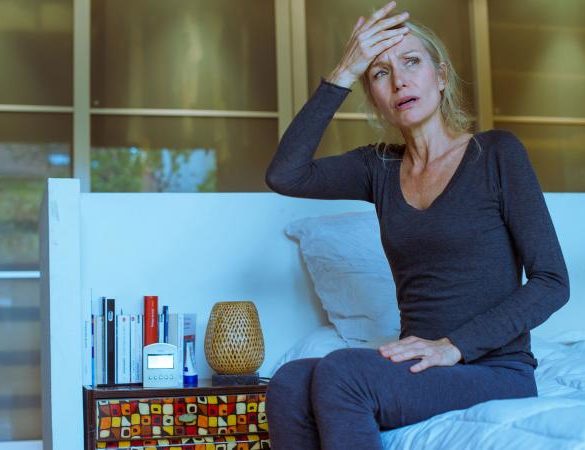 upset woman sitting on bed