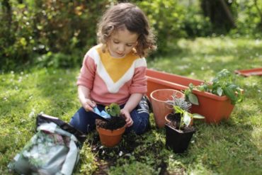 little girl potting plants