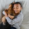 Boy hugging adopted dog
