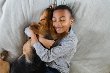 Boy hugging adopted dog