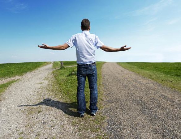 man standing at a fork in the road