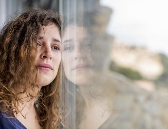 sad woman looking out window