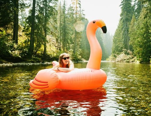 laughing woman floating down river