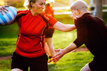 Woman rugby player holding ball