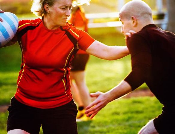 Woman rugby player holding ball